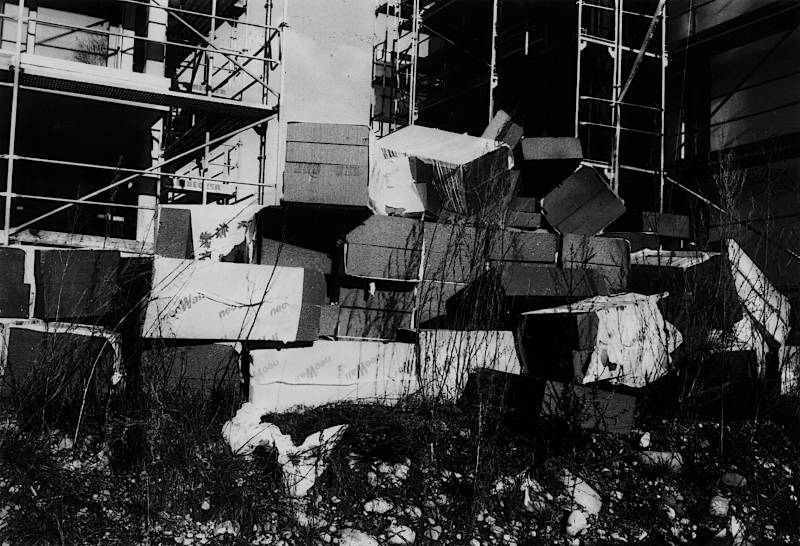black and white analogue photo of overturned foam pyramid on a construction site.