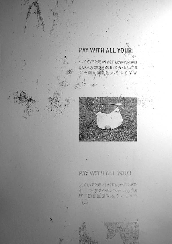 Fallen real estate posters become public sculptures. Motto text “Pay with all your […]” and then a list of various currency symbols. Laser print copy.