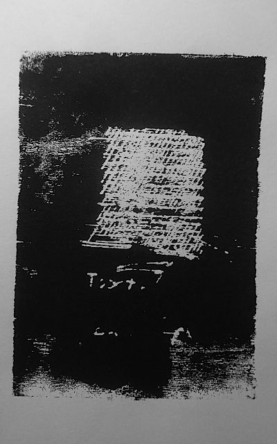 black wooden waste print. cross-out lines form a white rectangle. beneath the handwritten word, which is difficult to read, “Text.”