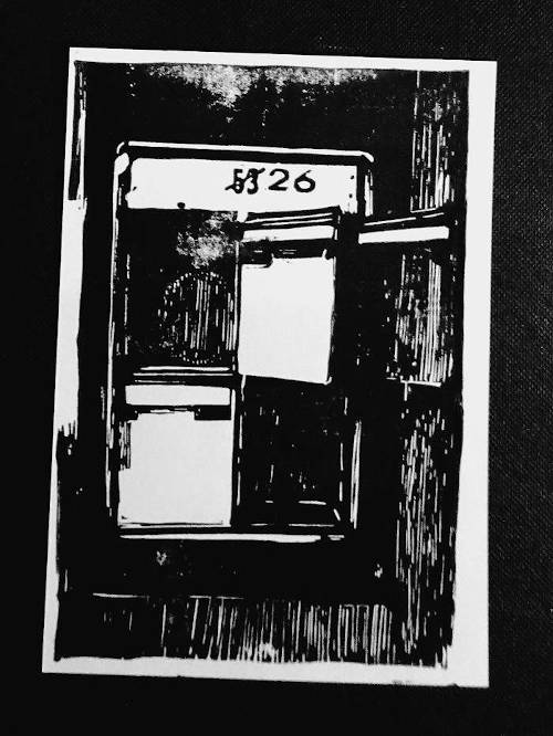A black linoleum print showing four mailboxes at the entrance of a house. the house number 53 has been crossed out and replaced by the new number 26. Three mailboxes are left open and empty. An abandoned mood.