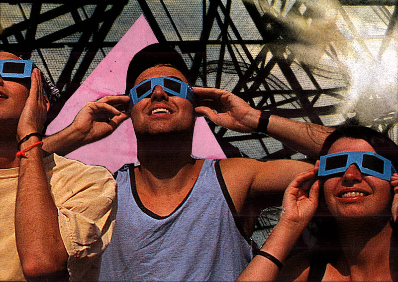 three young people wearing eclipse glasses look up at the sky, a metal lattice structure reflects the sund and blinds them