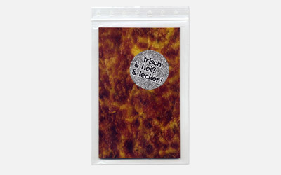 small book, pizza cover in a small plastic bag with title sticker